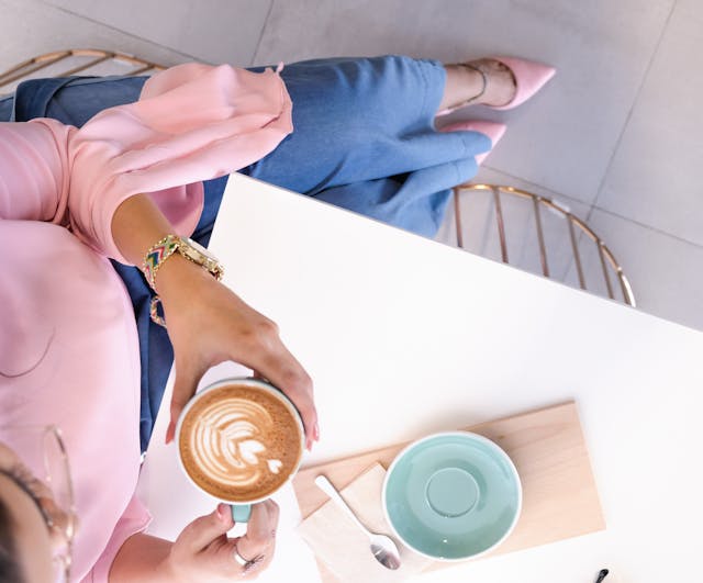 Einen Frau trinkt einen Cappuccino